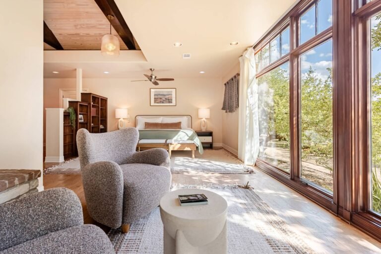 Primary suite with king bed and Pella windows at The Noble House, Driftwood Texas